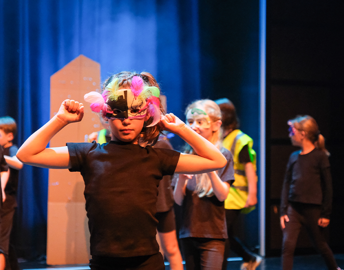 Children dancing on the stage while perfoming a scene in Gris